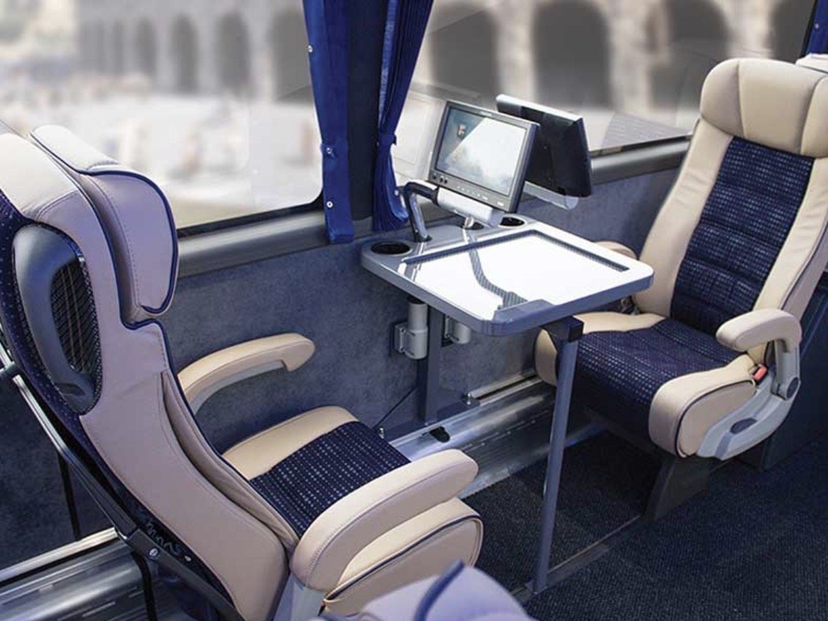 Luxuria coach seats with tray tables and personal screens