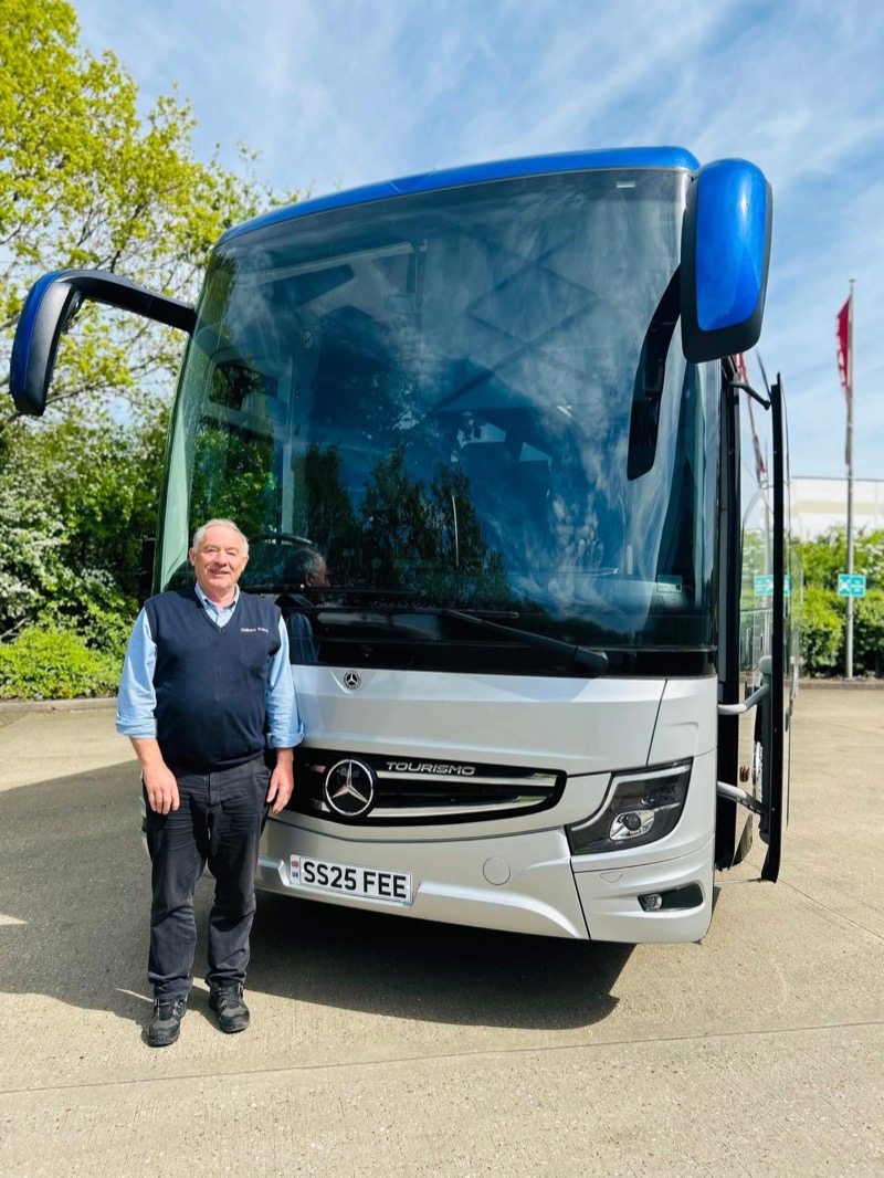 Trevor Boorman, owner of Chiltern Travel, standing with a Mercedes Tourismo coach
